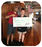 A man and a woman holding a huge check.